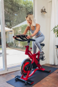 Girl on DIY Peloton indoor spin bike